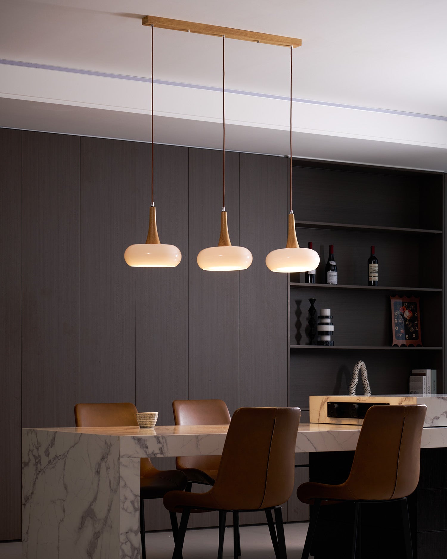 Modern interior with pendant lights, marble counter, and dark wall.